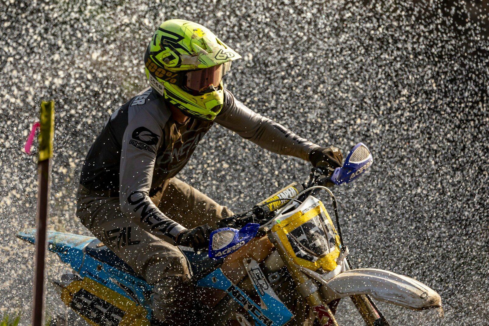 a man riding a dirt bike in the rain